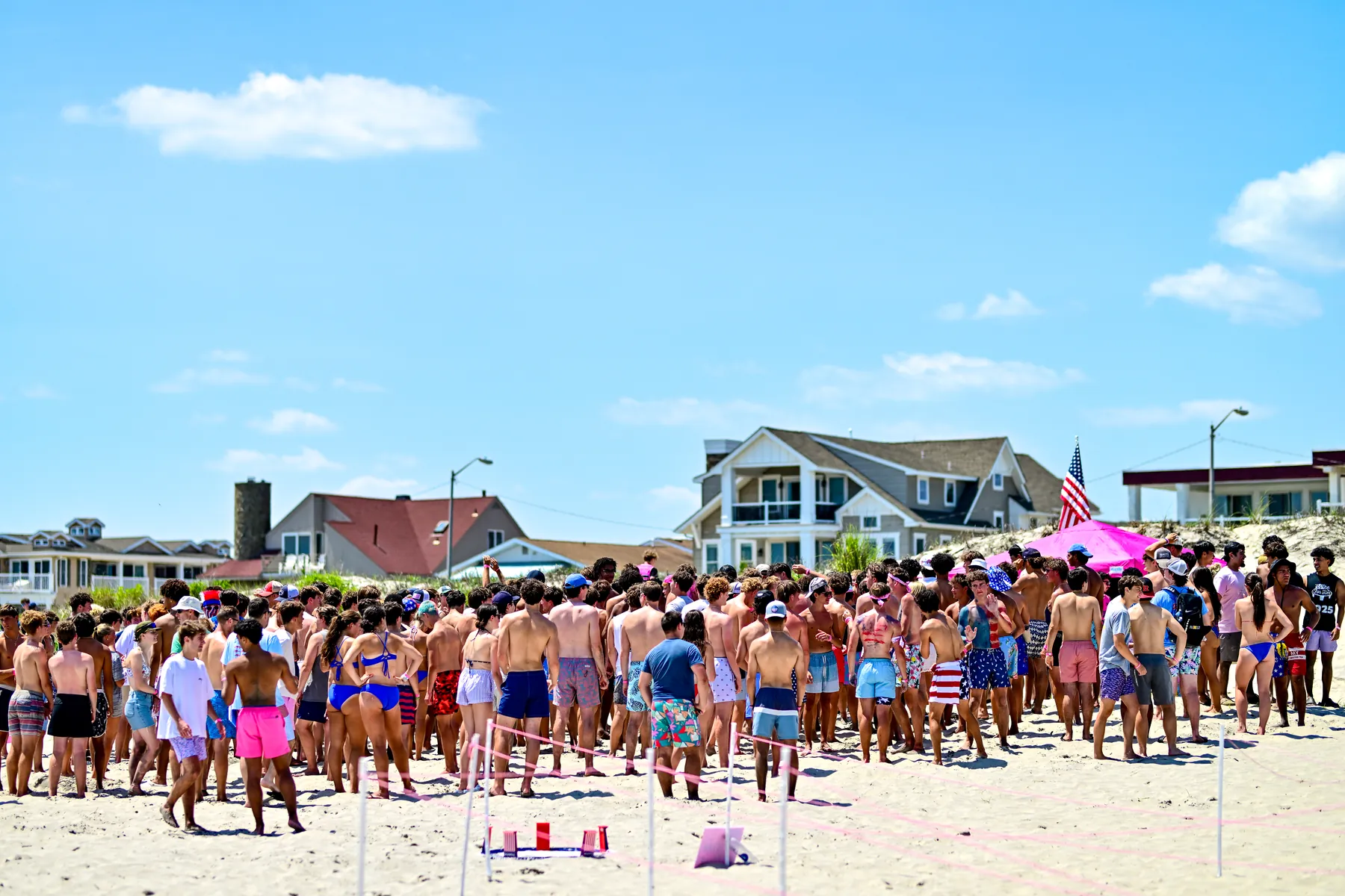 A huge crowd of players and spectators gathered on the Ocean City beach for Spike For Her, an American flag flying above them
